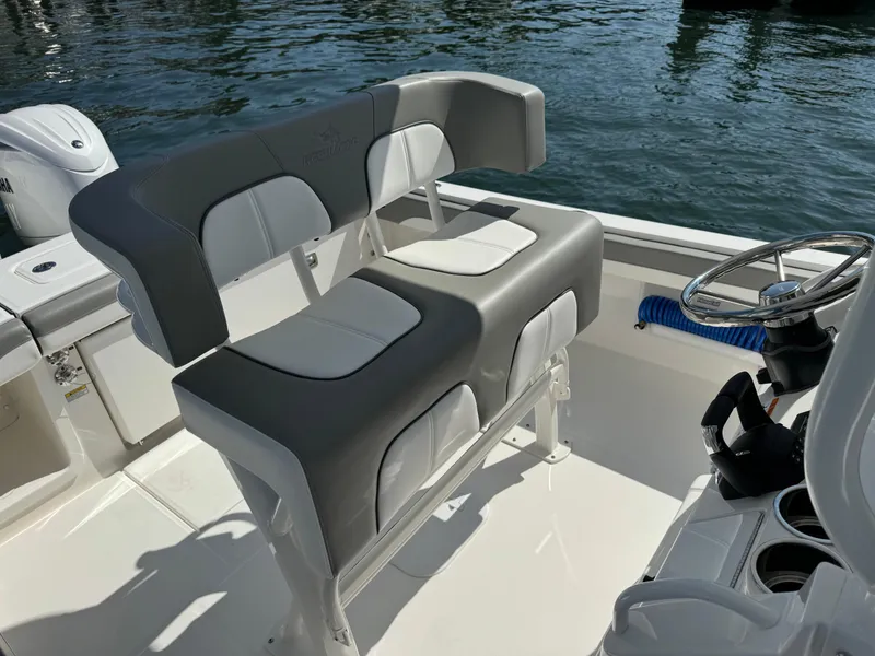 Slide: The Image of 2024 Regulator 23 boat interior with dual seating and steering wheel. - 38