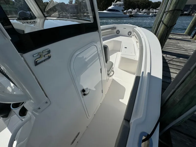 Slide: The Image of 2024 Regulator 23 boat docked, showcasing sleek design and spacious deck. - 41