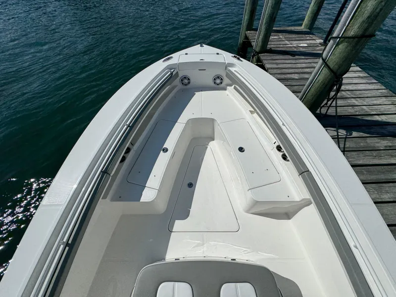 Slide: The Image of 2024 Regulator 23 boat docked, showcasing spacious deck and seating area. - 42