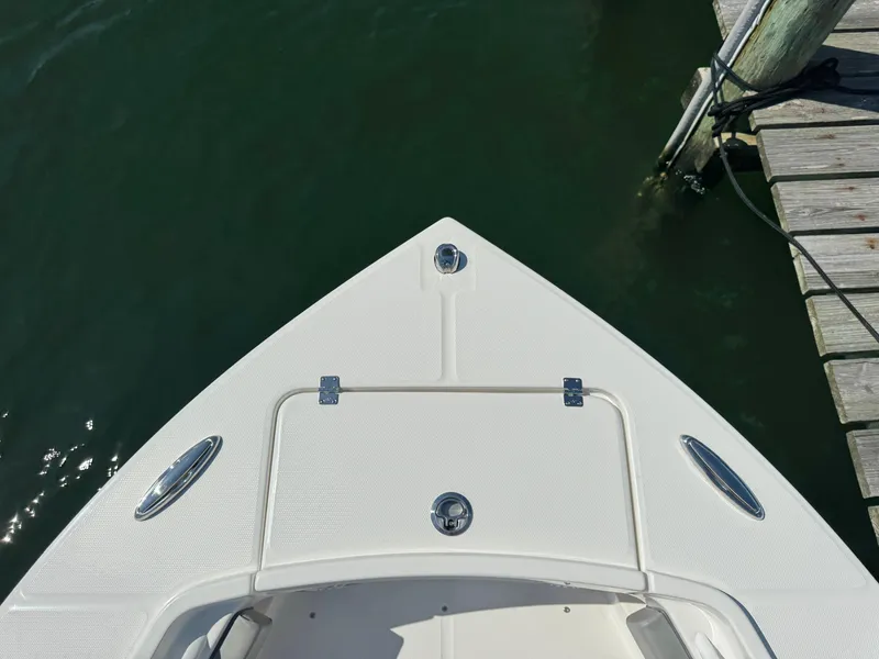 Slide: The Image of 2024 Regulator 23 boat bow at dock, featuring sleek design and white finish. - 44