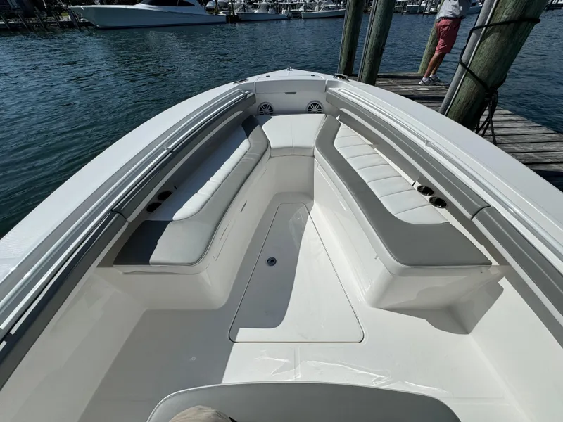 Slide: The Image of 2024 Regulator 23 boat with spacious seating at a marina dock. - 45