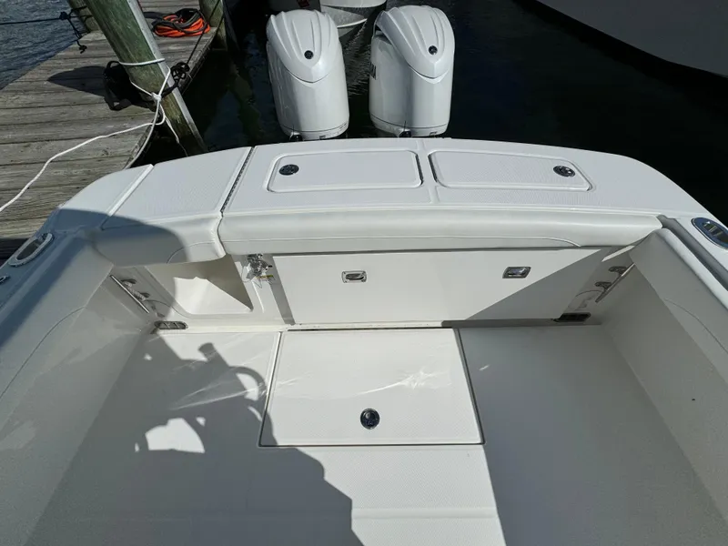 Slide: The Image of 2024 Regulator 23 boat with dual outboard motors at dock. - 14