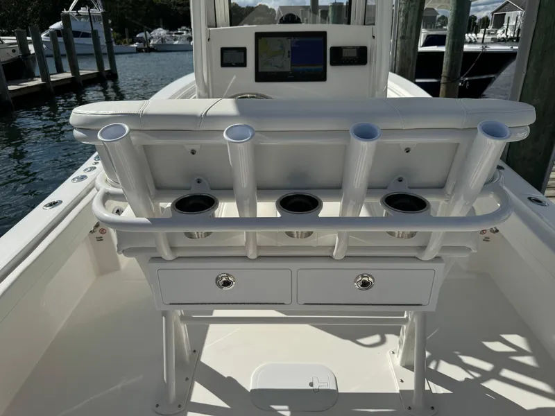 Slide: The Image of 2024 Regulator 23 boat cockpit with rod holders and storage drawers. - 17