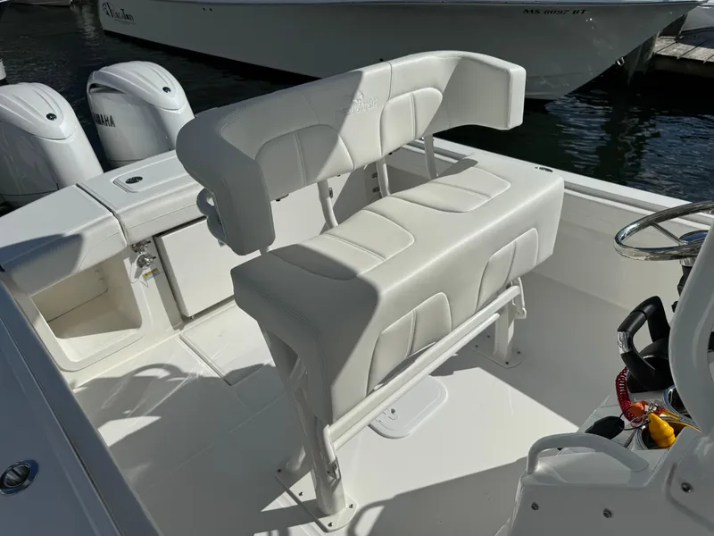 Slide: The Image of 2024 Regulator 23 boat interior with white seating and Yamaha engines. - 24