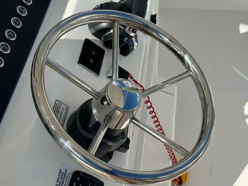 Slide: The Image of 2024 Regulator 23 boat steering wheel and controls, close-up view. - 28