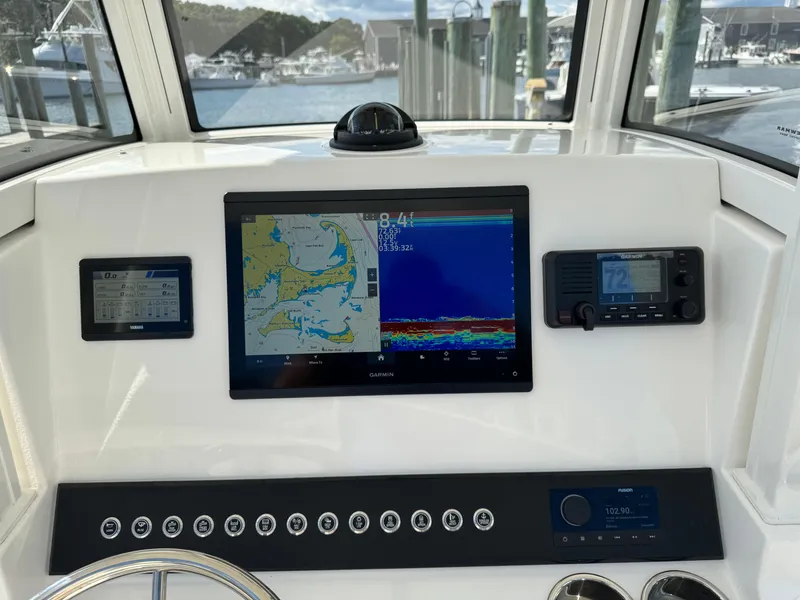 Slide: The Image of 2024 Regulator 23 boat dashboard with navigation and control systems. - 32
