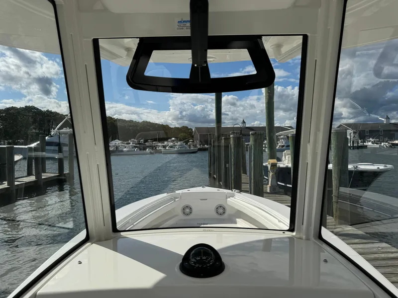Slide: The Image of 2024 Regulator 23 boat interior view at marina dock. - 33