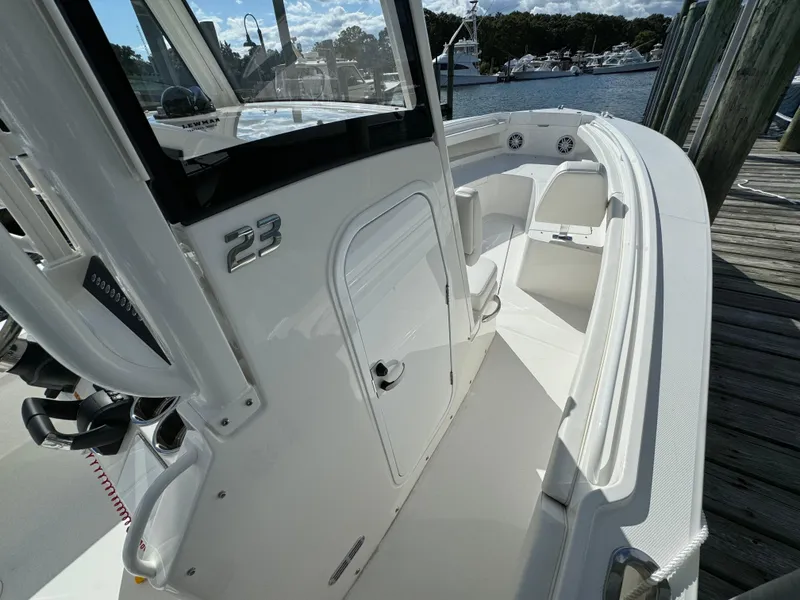 Slide: The Image of 2024 Regulator 23 boat interior, featuring sleek white design and spacious seating. - 35