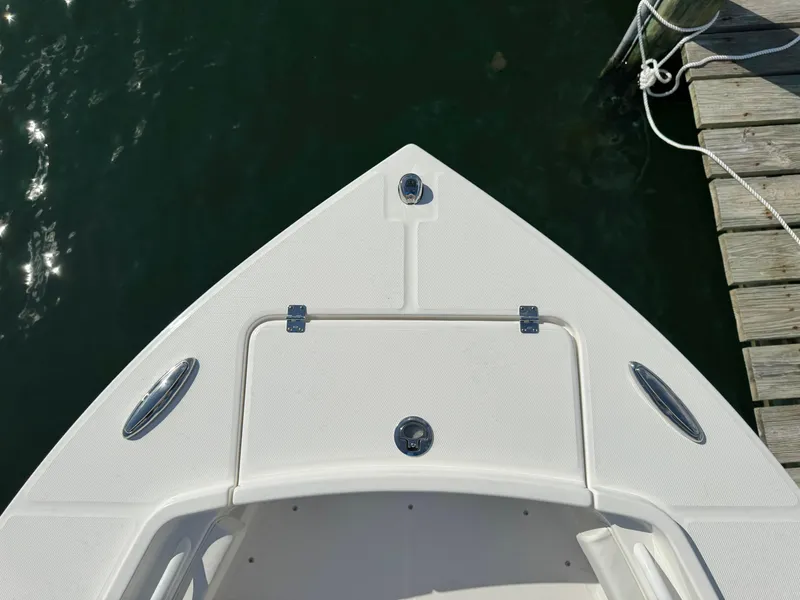 Slide: The Image of 2024 Regulator 23 boat bow at dock, featuring sleek design and white finish. - 38