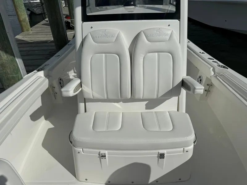 Slide: The Image of 2024 Regulator 23 boat with white cushioned seating and armrests. - 45
