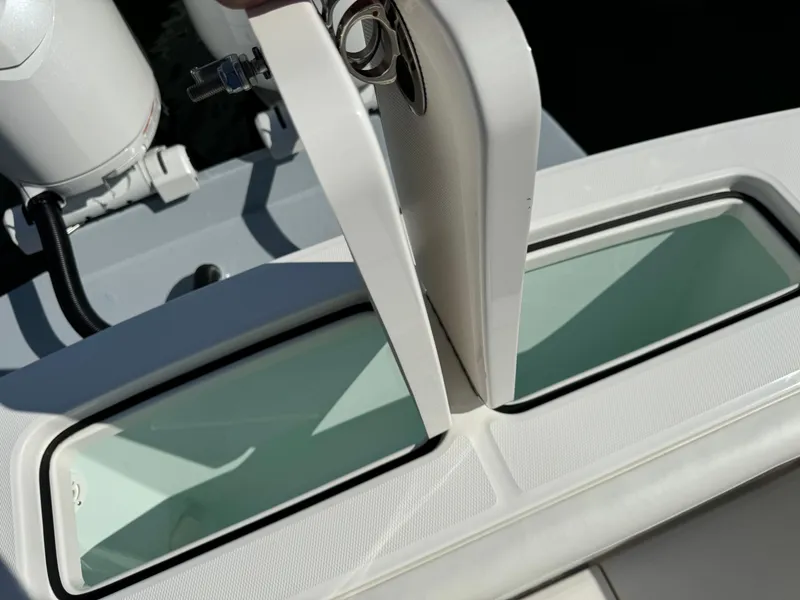 Slide: The Image of 2024 Regulator 23 boat with open storage compartments. - 13
