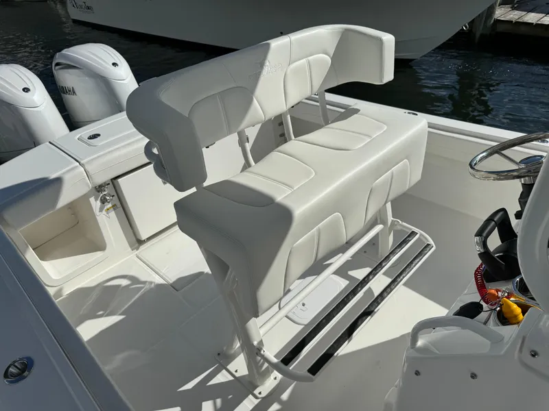 Slide: The Image of 2024 Regulator 23 boat interior with white cushioned seating and dual Yamaha engines. - 26