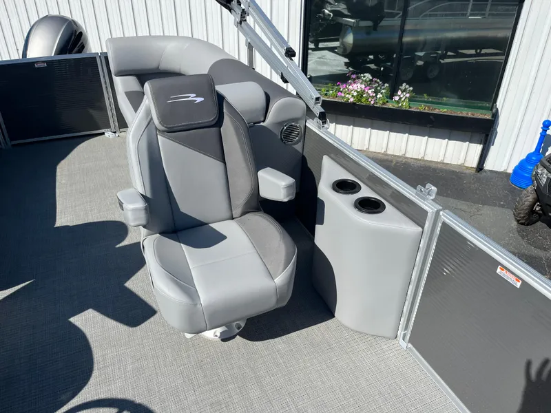 Slide: The Image of 2024 Bennington 22 SVSR boat interior with gray captain's chair and cup holders. - 12
