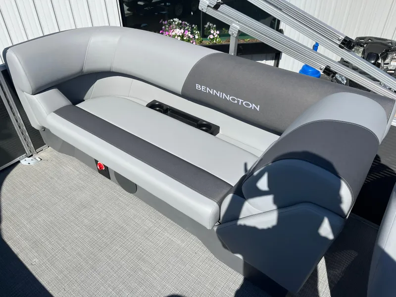 Slide: The Image of 2024 Bennington 22 SVSR pontoon boat seating area with gray and black upholstery. - 14