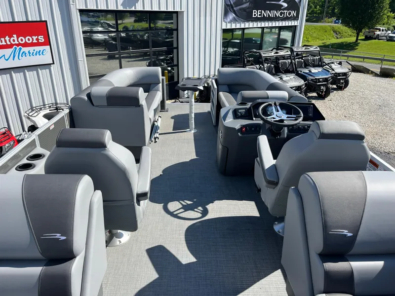 Slide: The Image of 2024 Bennington 22 SVSR pontoon boat interior with gray seating and steering console. - 15