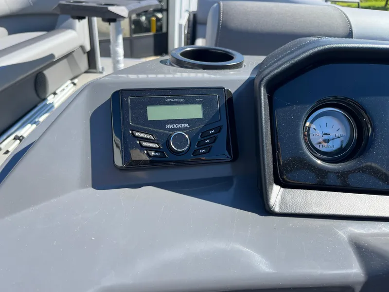 Slide: The Image of 2024 Bennington 22 SVSR boat dashboard with Kicker audio system and trim gauge. - 18