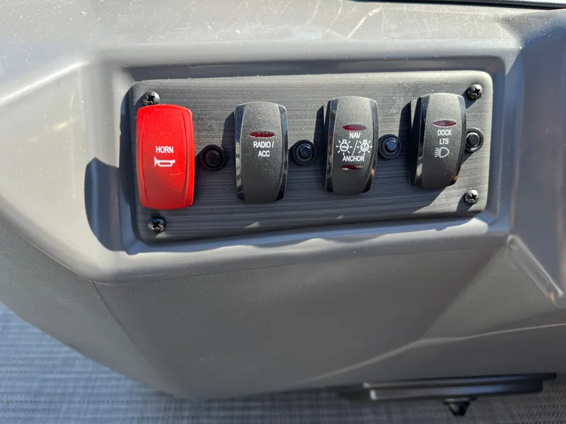 Slide: The Image of Control panel of a 2024 Bennington 22 SVSR boat with various switches. - 19