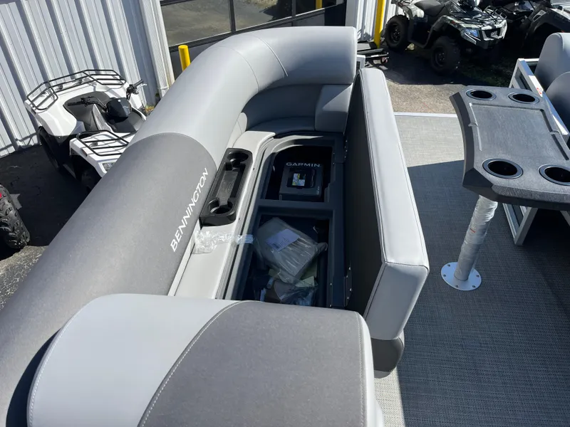 Slide: The Image of 2024 Bennington 22 SVSR pontoon boat with gray seating and storage compartments. - 21