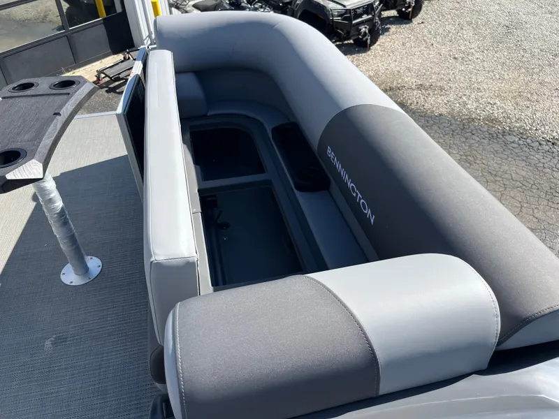 Slide: The Image of 2024 Bennington 22 SVSR pontoon boat interior with gray seating and storage compartments. - 22
