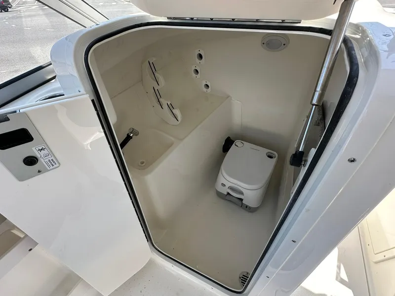 Slide: The Image of 2024 Key West 239 DFS boat interior with compact marine toilet. - 10