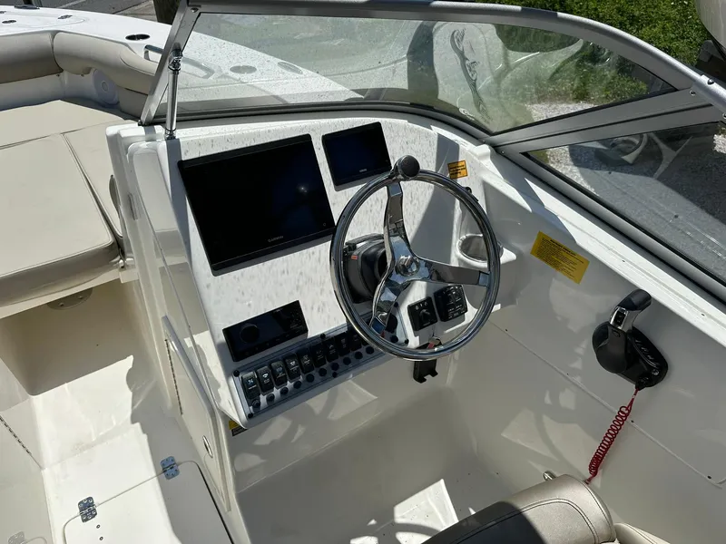 Slide: The Image of 2024 Key West 239 DFS boat dashboard with steering wheel and control panel. - 7
