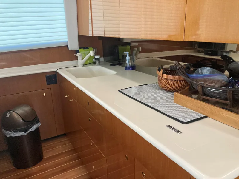 Slide: The Image of 1999 Viking 55 Sport Fish yacht kitchen with wooden cabinets and countertop. - 13