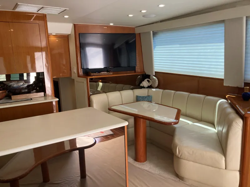 Slide: The Image of Interior of 1999 Viking 55 Sport Fish yacht with leather seating and TV. - 16