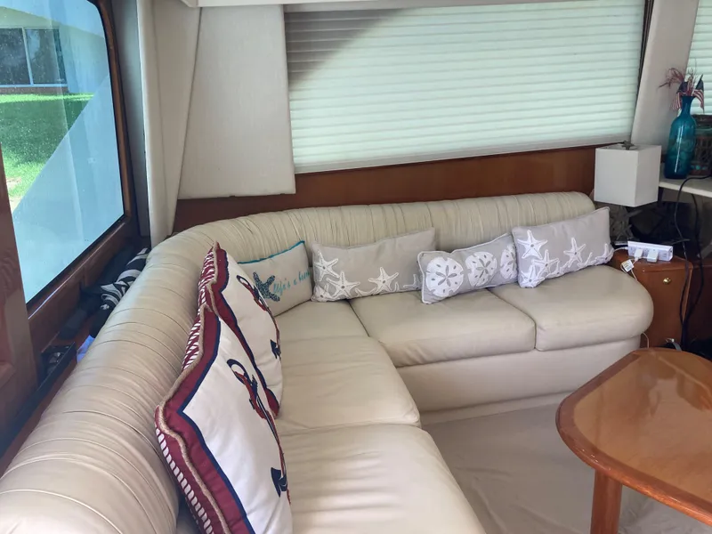 Slide: The Image of Interior of 1999 Viking 55 Sport Fish yacht with beige sofa and nautical-themed pillows. - 18