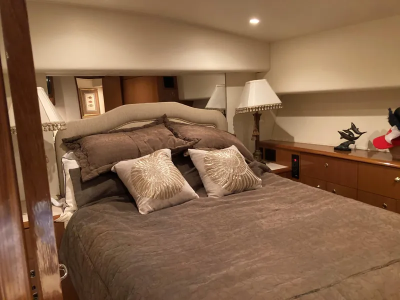 Slide: The Image of Luxurious bedroom interior of a 1999 Viking 55 Sport Fish yacht. - 23