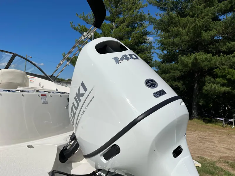 Slide: The Image of 2024 Stingray 201 DC boat with Suzuki 140 outboard motor. - 11