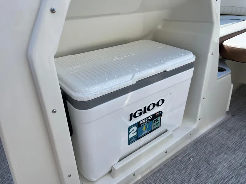 Slide: The Image of Igloo cooler stored in 2024 Stingray 201 DC boat compartment. - 13