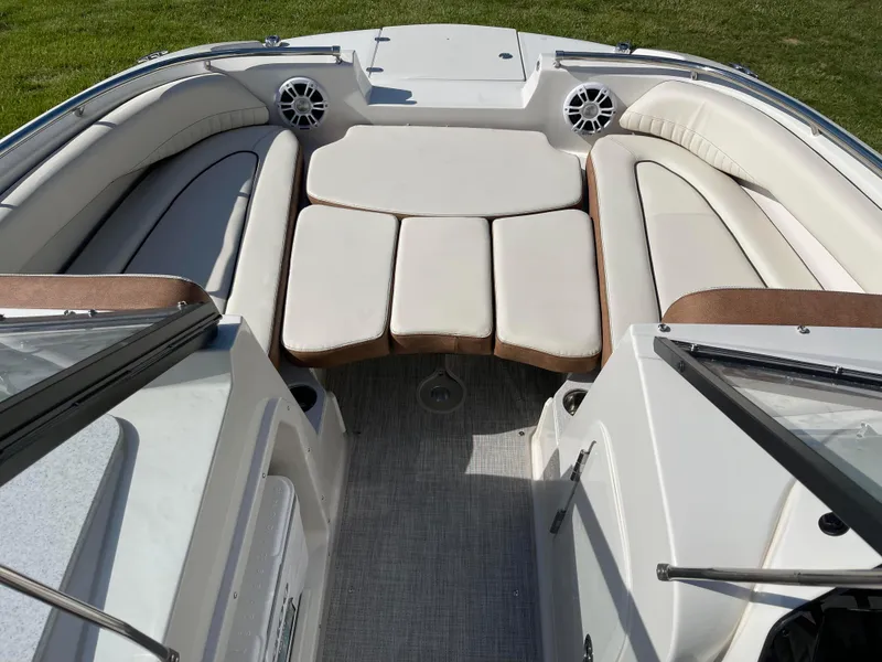 Slide: The Image of 2024 Stingray 201 DC boat interior with cushioned seating and speakers. - 4