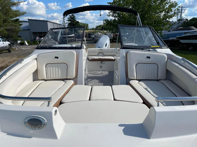 Slide: The Image of 2024 Stingray 201 DC boat interior with white seating and open deck. - 5