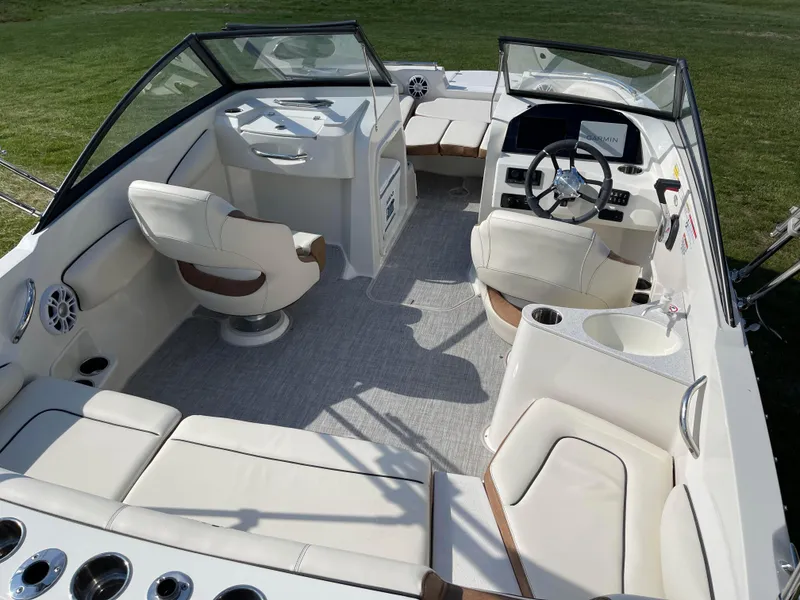 Slide: The Image of 2024 Stingray 201 DC boat interior with white leather seating and modern dashboard. - 6