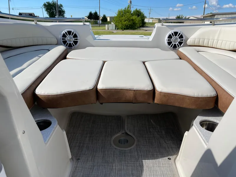 Slide: The Image of 2024 Stingray 201 DC boat interior with cushioned seating and cup holders. - 7