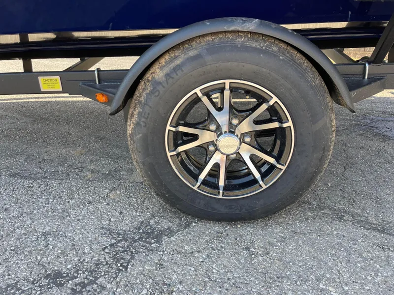 Slide: The Image of Close-up of a 2024 G3 Sportsman 1710 PFX trailer wheel on asphalt. - 10