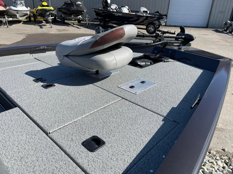 Slide: The Image of 2024 G3 Sportsman 1710 PFX fishing boat deck with seat and storage compartments. - 11