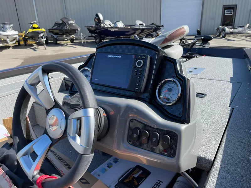 Slide: The Image of 2024 G3 Sportsman 1710 PFX boat dashboard with steering wheel and navigation system. - 13