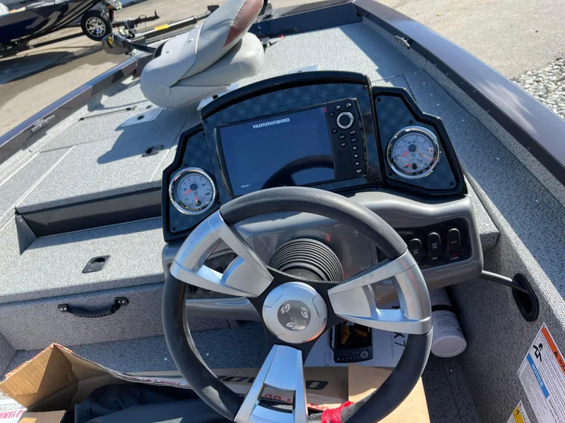 Slide: The Image of 2024 G3 Sportsman 1710 PFX boat dashboard with steering wheel and navigation system. - 3