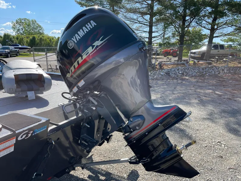Slide: The Image of 2024 G3 Sportsman 1710 PFX boat with Yamaha outboard motor in a parking lot. - 5