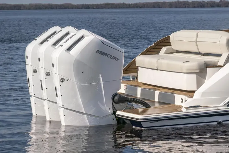 Slide: The Image of 2023 Tiara Yachts 48 LS with triple Mercury outboard engines on calm water. - 10