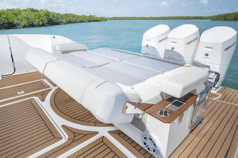 Slide: The Image of 2023 Tiara Yachts 48 LS with triple Mercury outboard engines on a teak deck. - 14