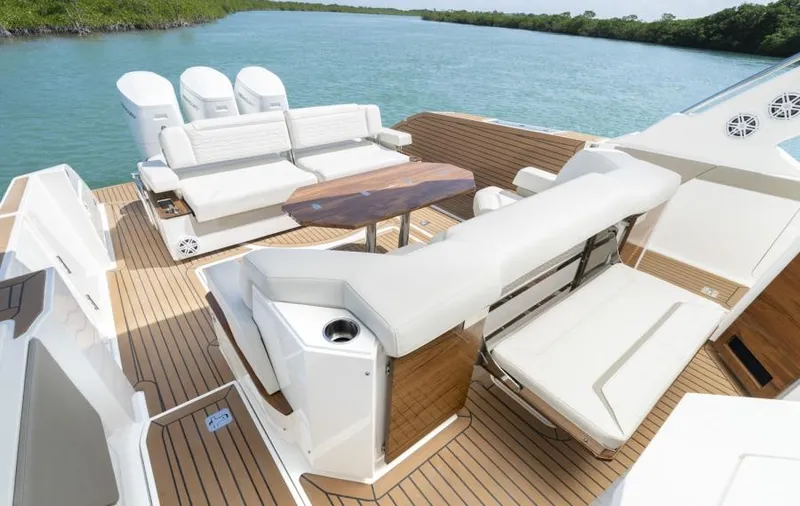 Slide: The Image of 2023 Tiara Yachts 48 LS luxury boat deck with seating and table. - 20