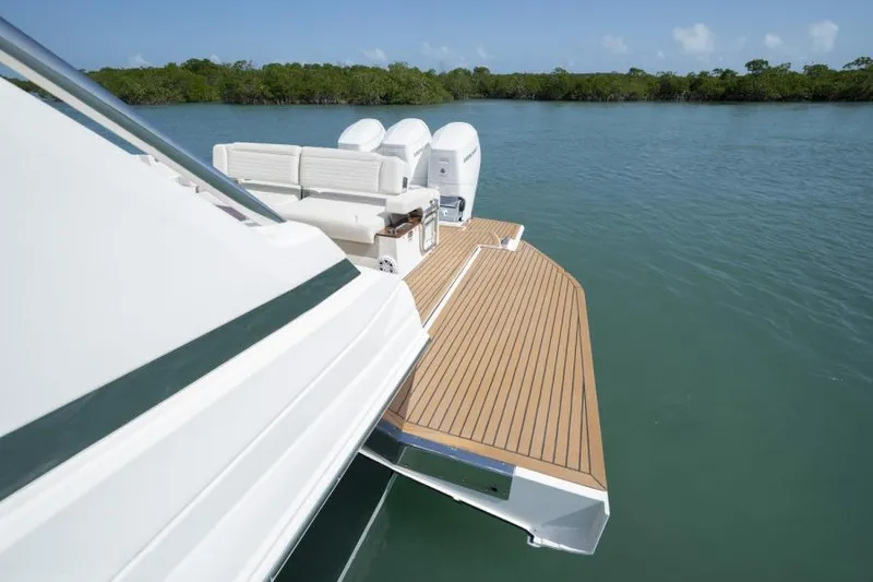 Slide: The Image of 2023 Tiara Yachts 48 LS with triple outboard engines and spacious deck. - 21