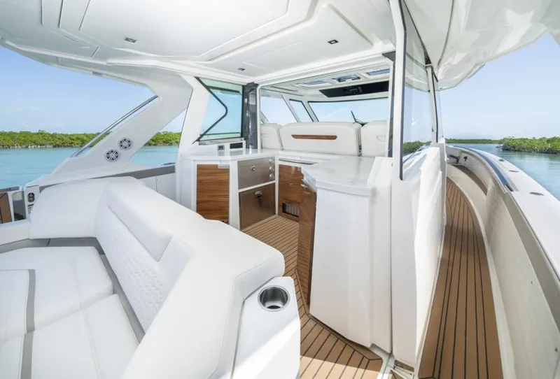 Slide: The Image of 2023 Tiara Yachts 48 LS interior with white seating and wooden cabinetry. - 26