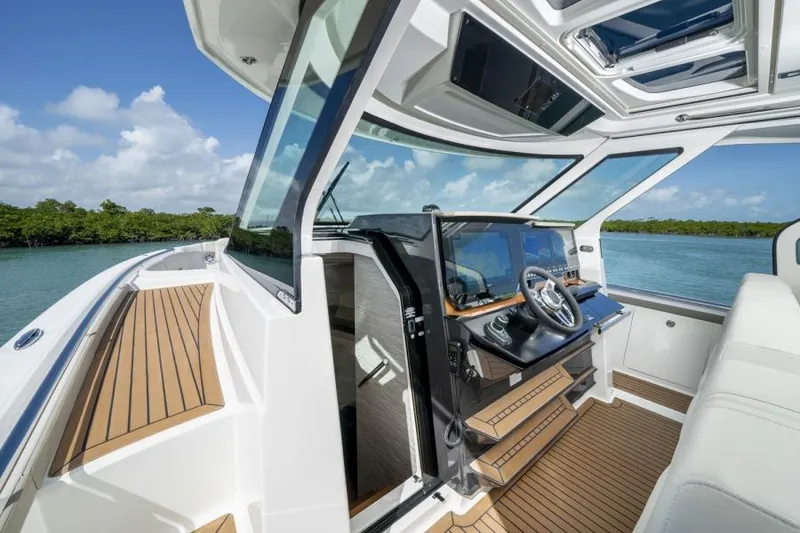 Slide: The Image of 2023 Tiara Yachts 48 LS helm station with modern controls and panoramic views. - 27
