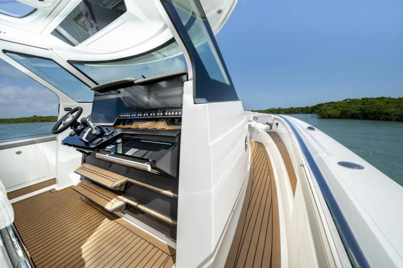 Slide: The Image of 2023 Tiara Yachts 48 LS helm station with teak flooring and modern controls. - 28