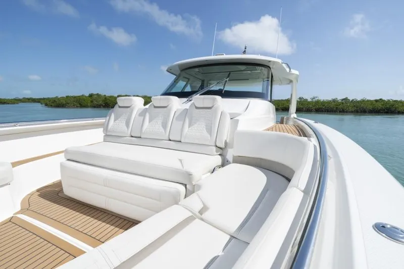 Slide: The Image of 2023 Tiara Yachts 48 LS luxury boat with white seating and teak deck. - 29