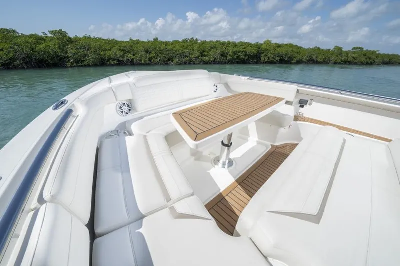 Slide: The Image of 2023 Tiara Yachts 48 LS boat with luxurious seating and wooden table. - 30