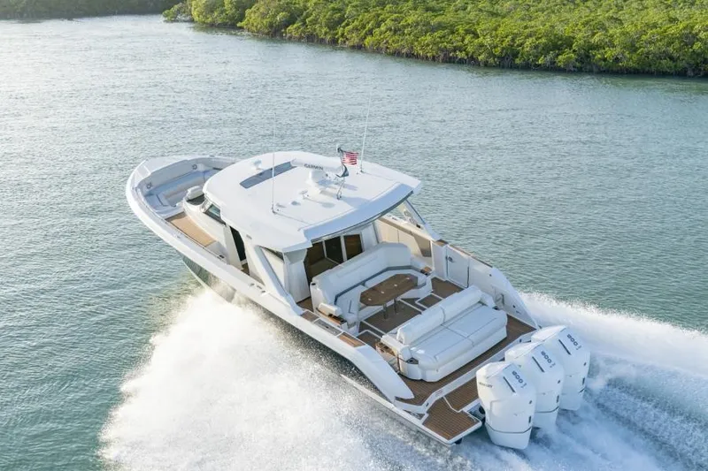 Slide: The Image of 2023 Tiara Yachts 48 LS cruising on water, rear view. - 5